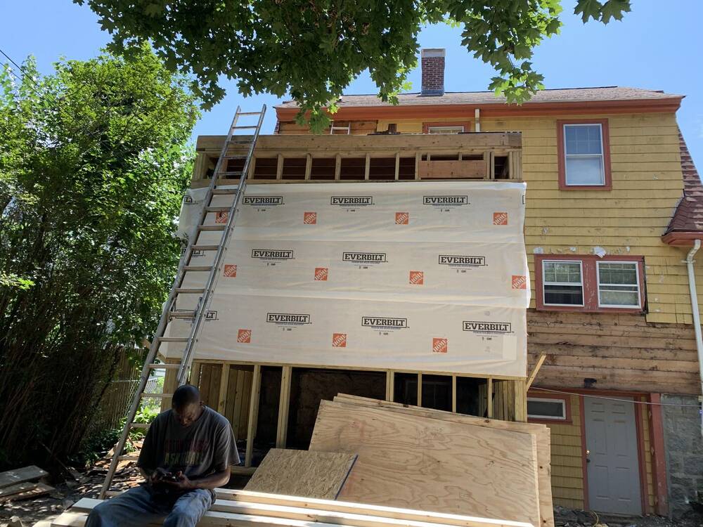Rear addition first floor framed and wrapped against the existing house