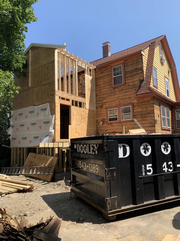 Two-story rear addition framed beside the original gambrel house