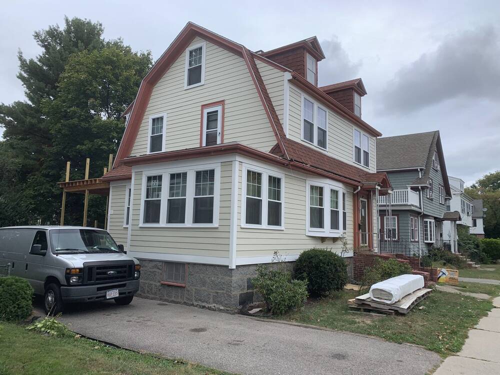 Finished Dutch colonial with new siding, windows and trim