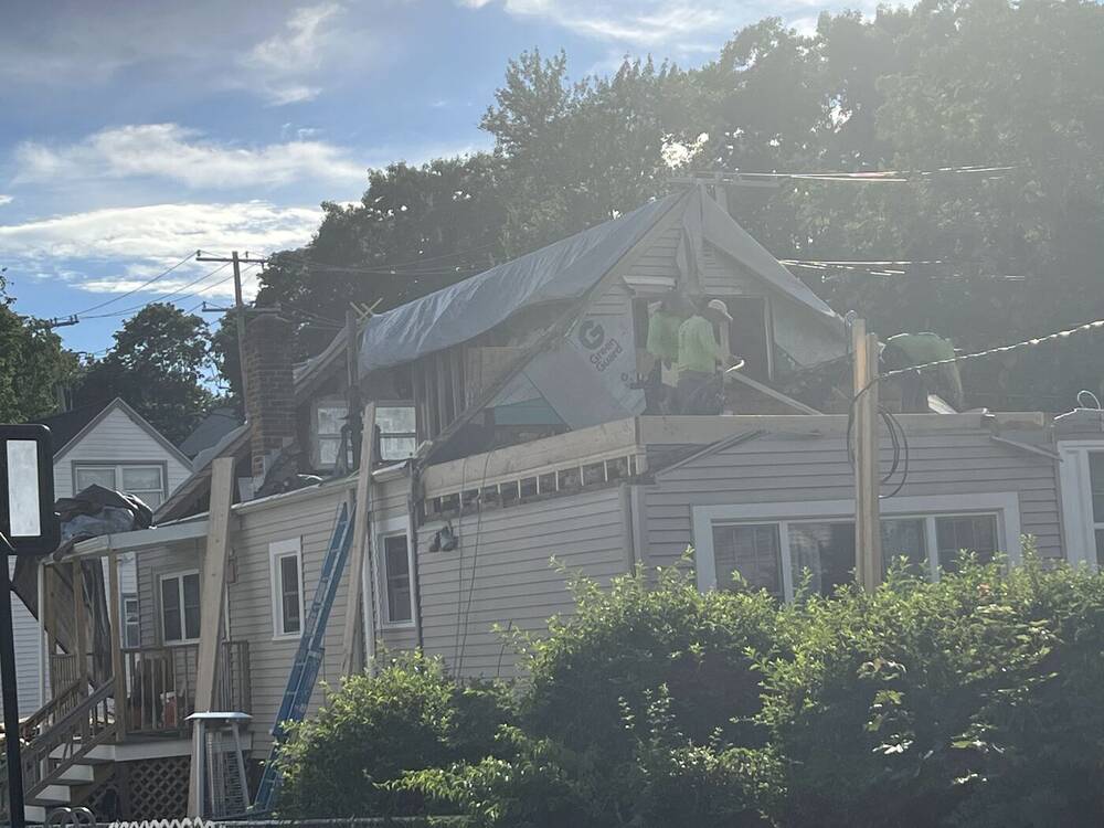 Original roof opened up and tarped as the addition begins