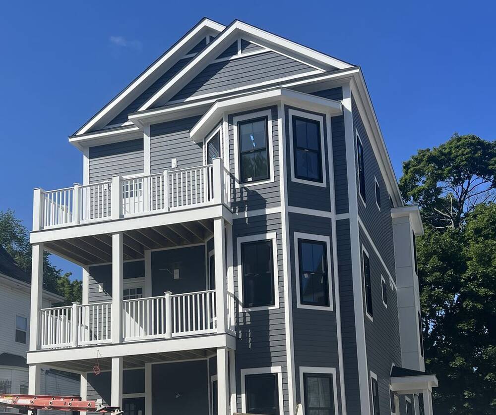 Front of the three-story house with stacked white porches