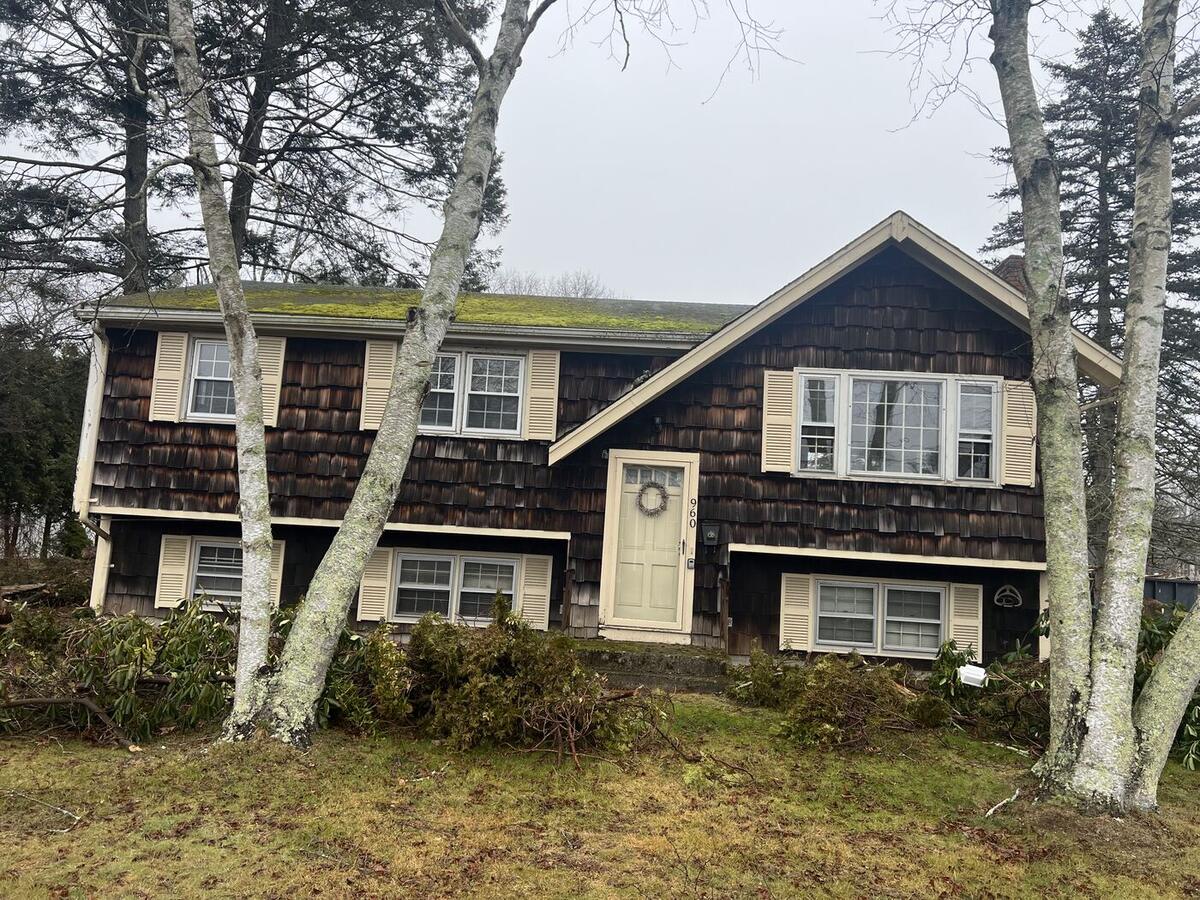 Split-level house before remodel, with old cedar shingle siding
