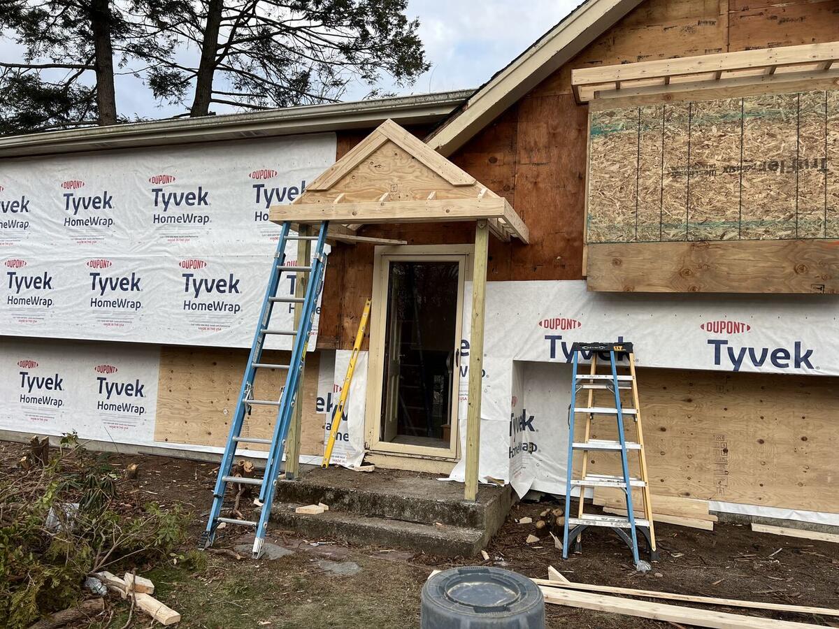 New front gable bump-out and entry portico framed and sheathed
