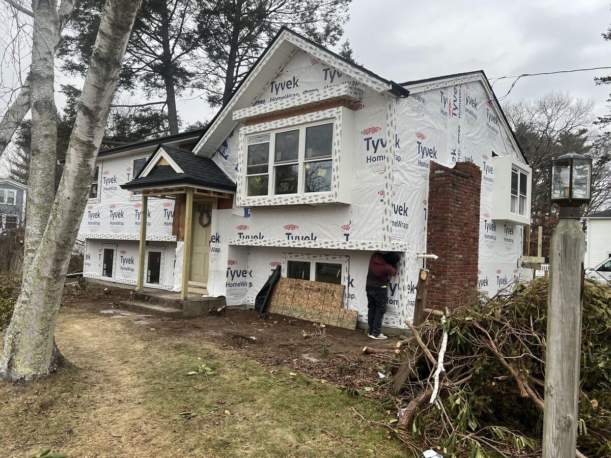 Addition wrapped in housewrap with new windows installed