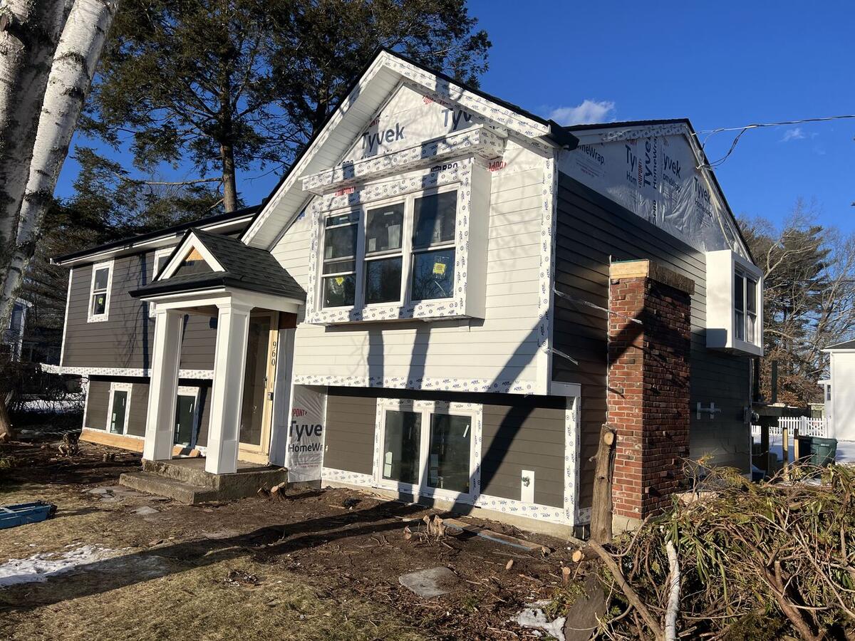 White and charcoal siding being installed