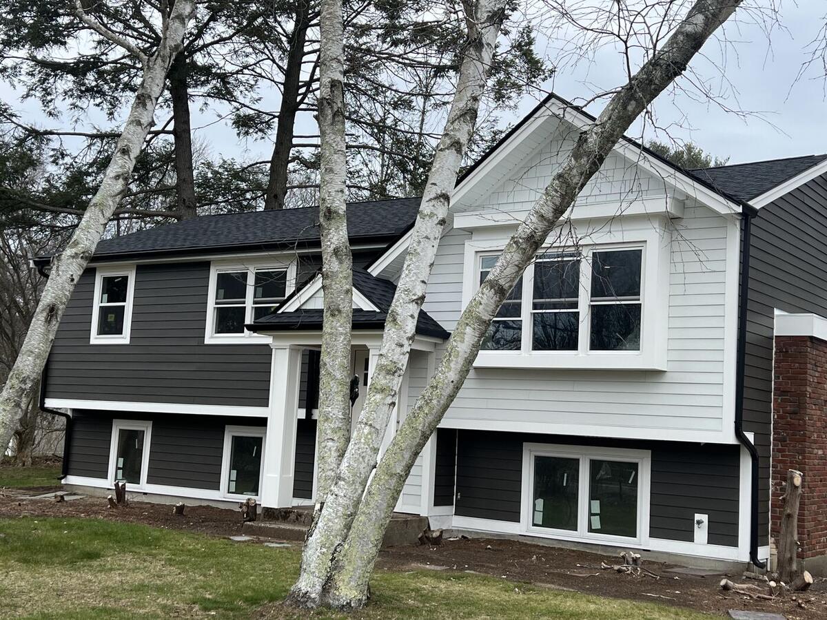 Finished split-level remodel with gable bump-out, portico, siding and roof in Abington, MA