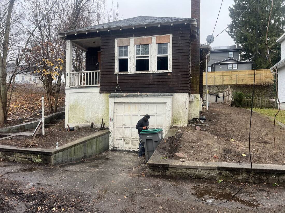 Original one-story bungalow over a garage before the addition