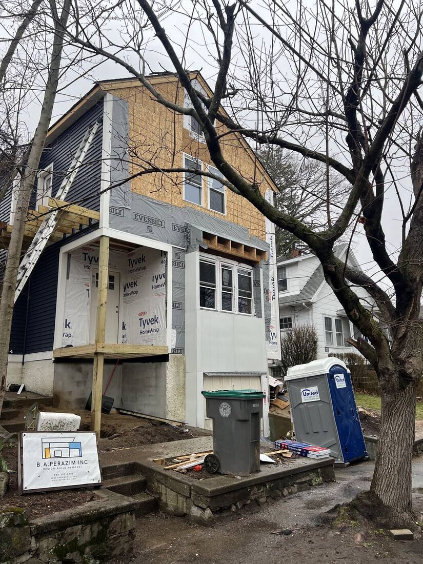 Front entry and porch framing with new windows installed