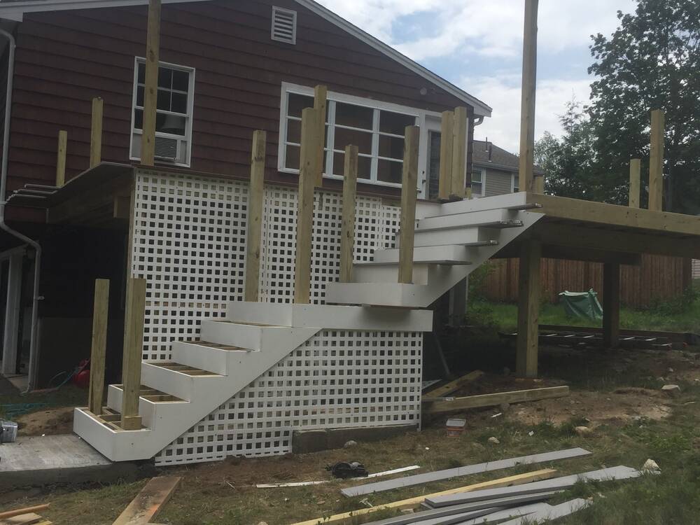 New stairs with white risers and lattice skirting, posts in place