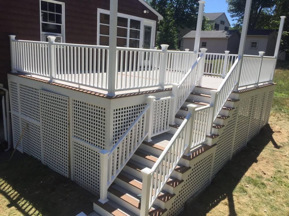 Finished two-level composite deck with white railings and lattice skirting