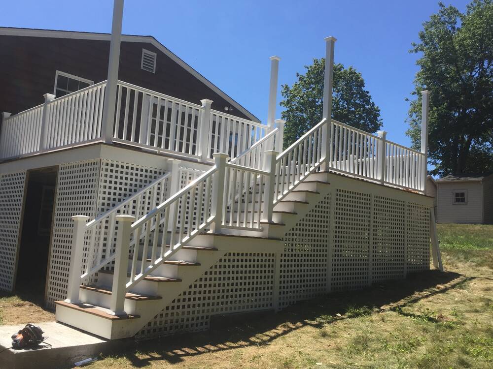 Finished composite deck and two-flight stairs from the side yard