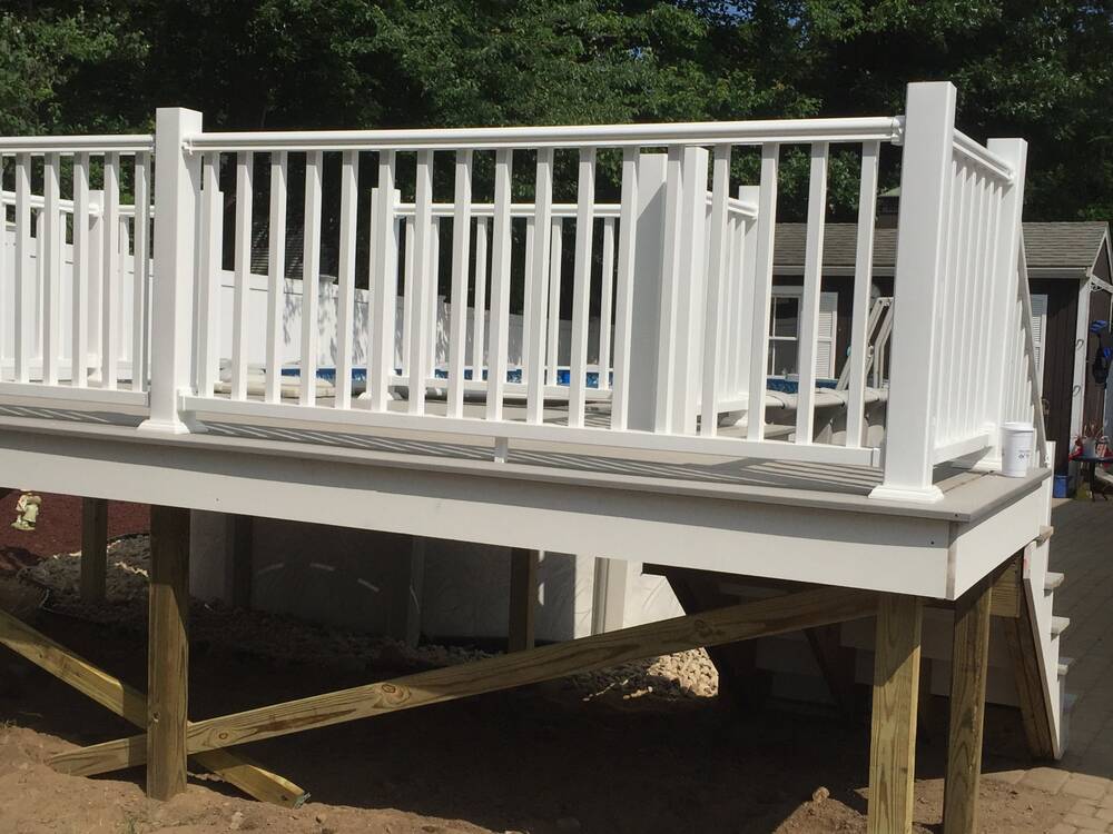 Corner of the pool deck with white railings