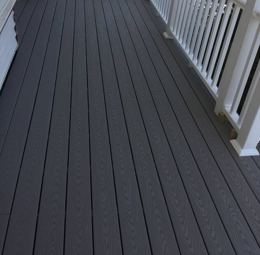 Gray composite decking and white railings on the front porch