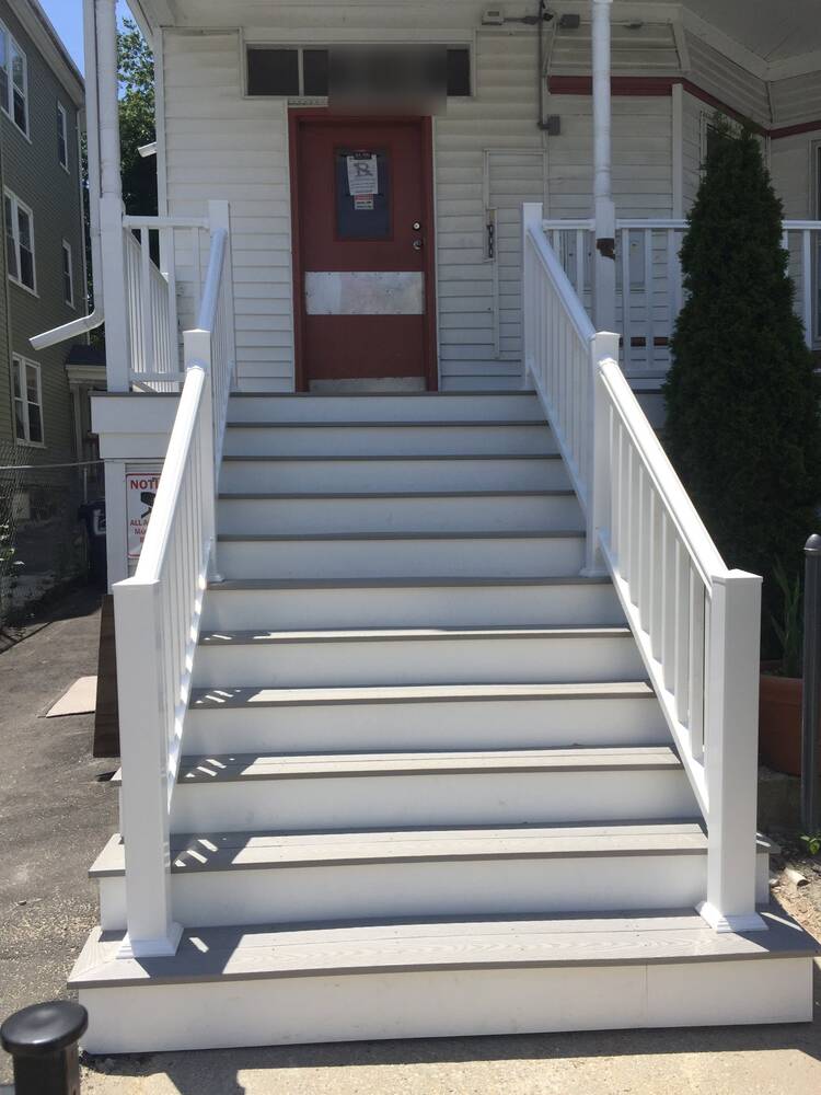 Finished front stairs with gray composite treads and white railings