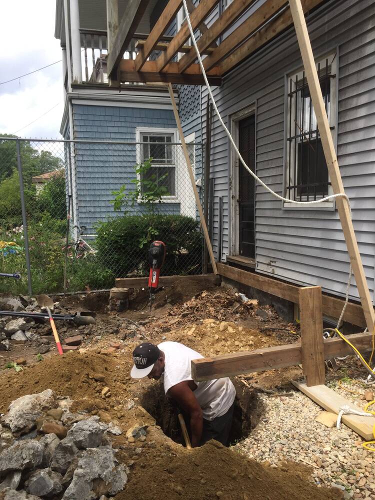 Crew digging deep footings for the new porch posts