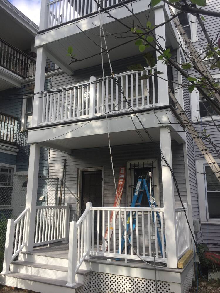 Finished rear porches with new stairs, composite decking and white railings