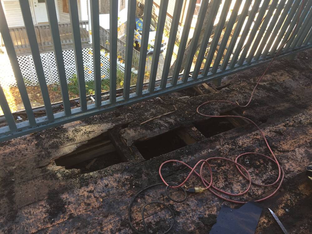Old porch decking rotted through to the joists
