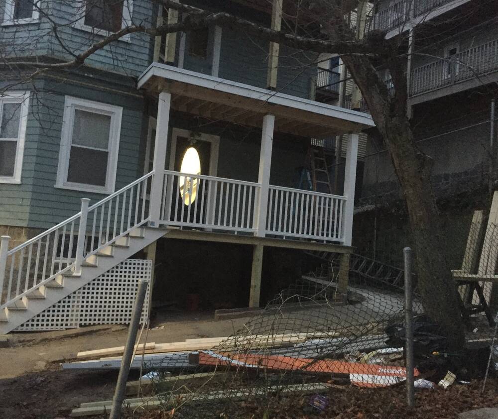 White columns and railings installed on the first-floor porch