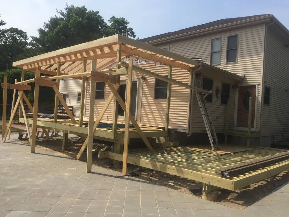 Covered porch framed and braced, with the lower deck framing complete