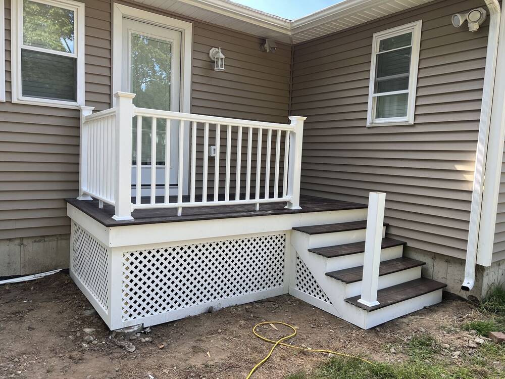 White railings, trim and lattice skirting installed