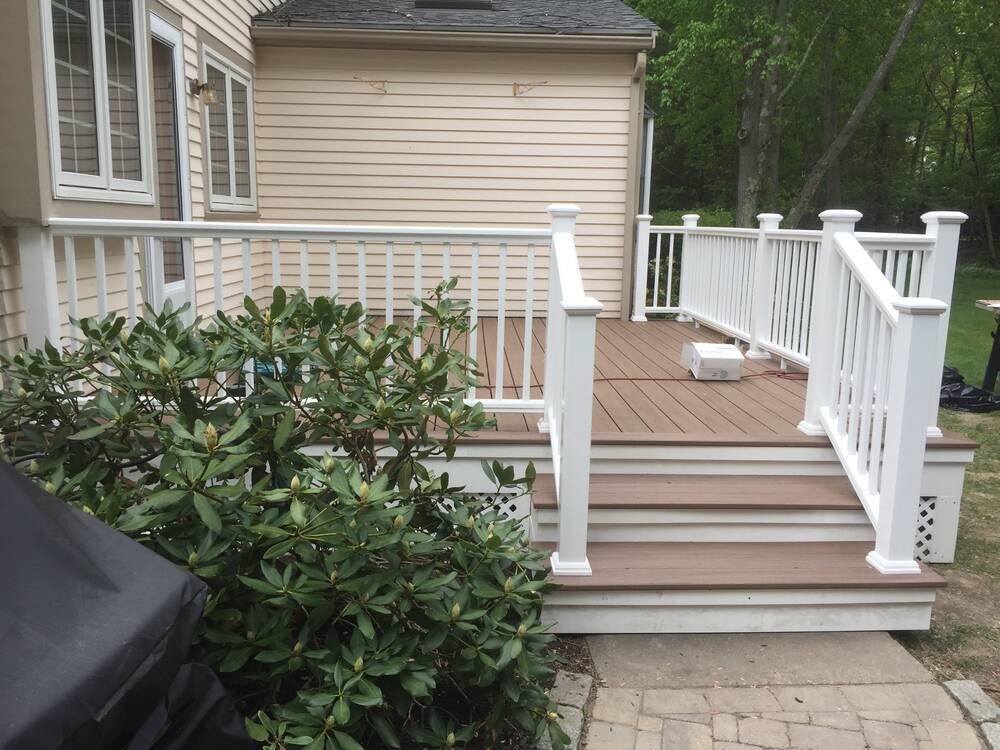 Finished deck stairs with composite treads and white railings
