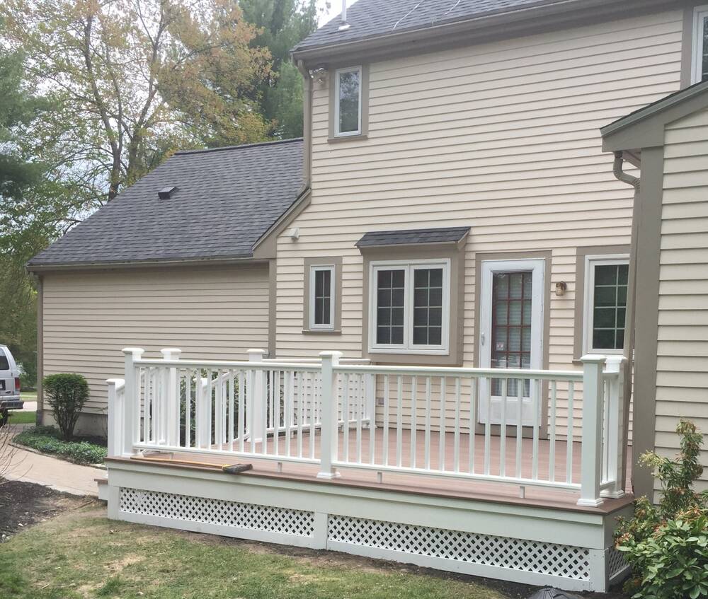 Finished composite deck with white railings and lattice skirting