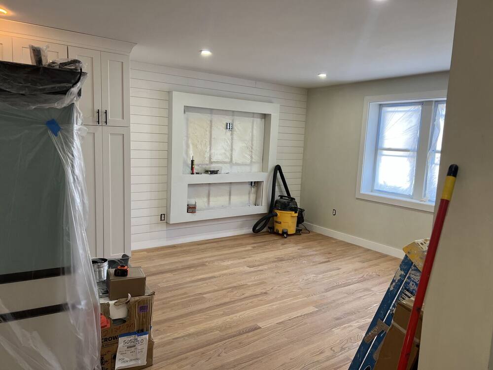 Open room with shiplap wall, ready for the new kitchen