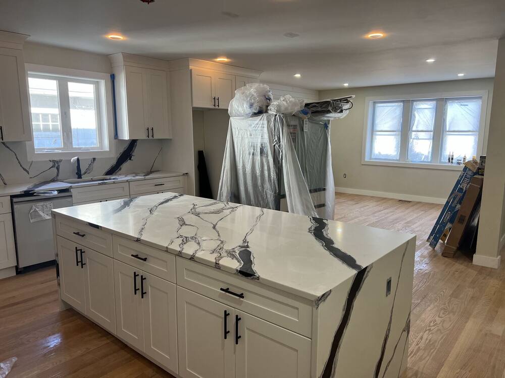 White cabinets and a bold marble-look waterfall island installed