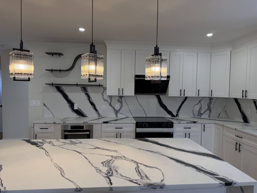 Waterfall island with glass pendant lights over it
