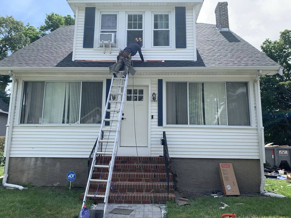 New gray architectural shingles installed on the bungalow and its dormer