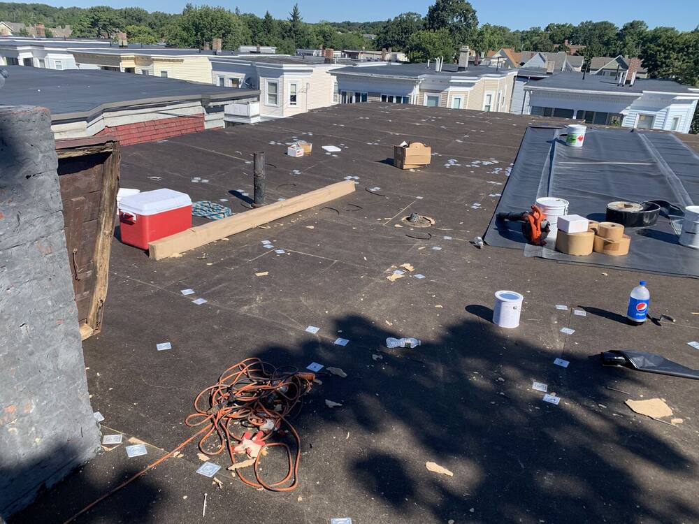Flat roof with new insulation board fastened down